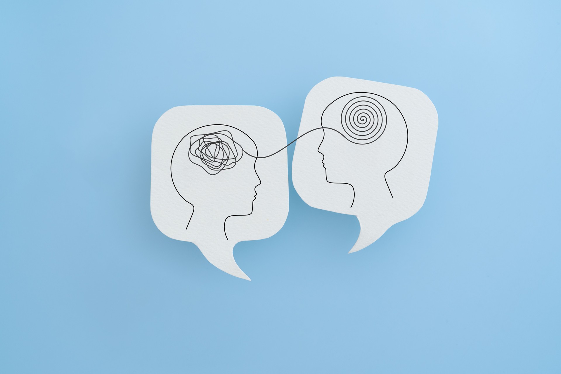 Mental health, brain disorder, World mental health day, Alzheimer, Psychology concept. Human head with Tangle of thoughts and clear line on real white speech bubble paper cut with blue background Mental health, brain disorder, World mental health day, Alzheimer, Psychology concept. Human head with Tangle of thoughts and clear line on real white speech bubble paper cut with blue background
